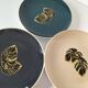Set of 7 porcelain plates, gold foliage & jungle