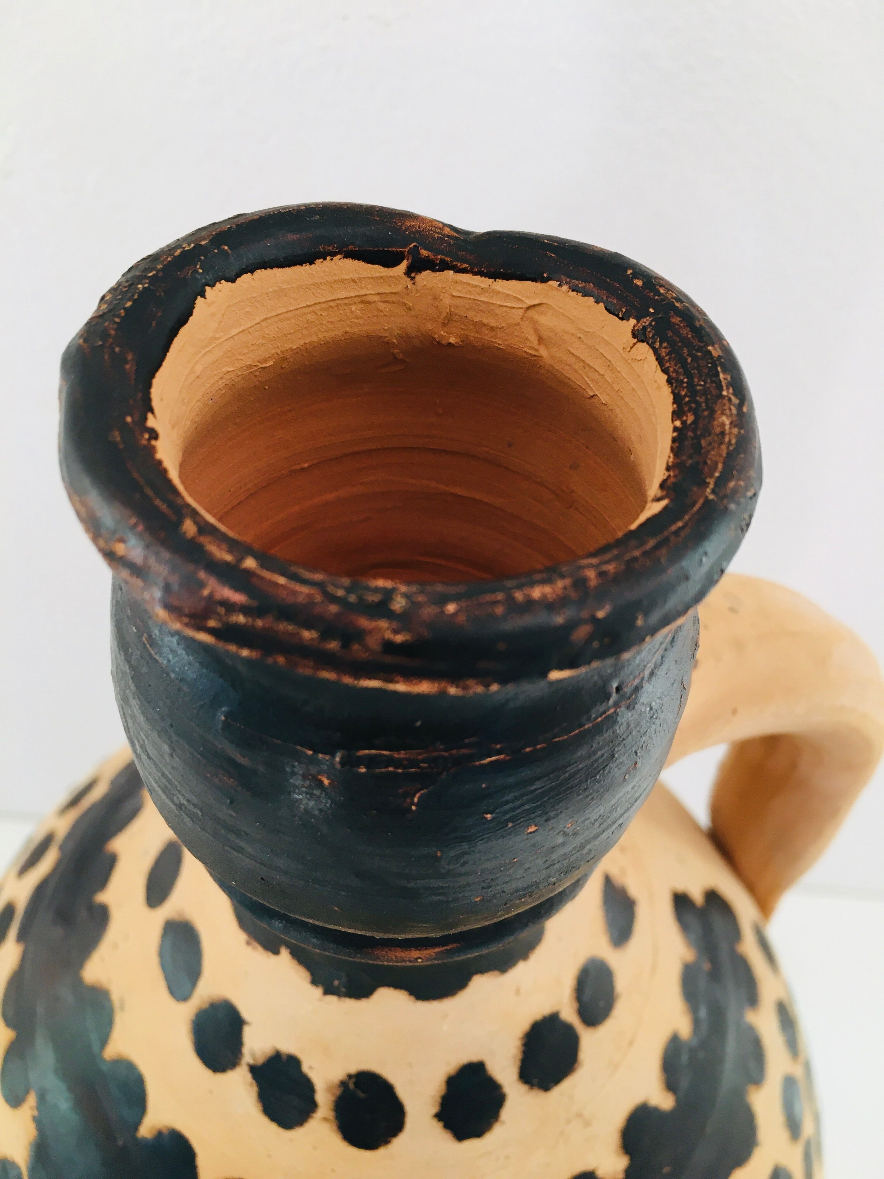 Raw and black terracotta jug