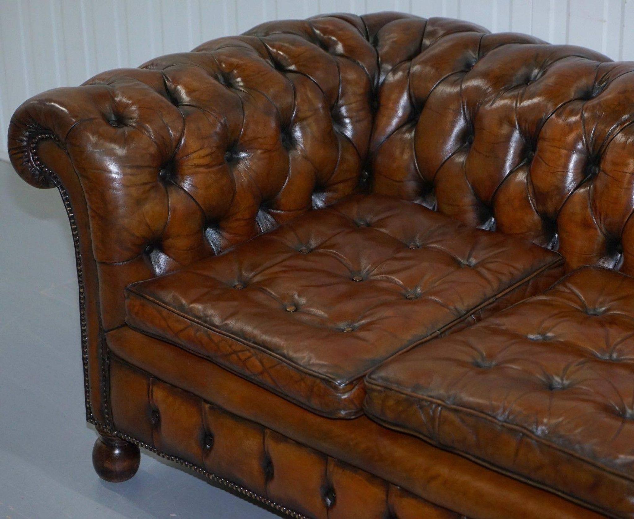 Restored vintage leather Chesterfield canapé in Thomas Chippendale style.