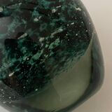 Glass bottle with silver glitter inclusions