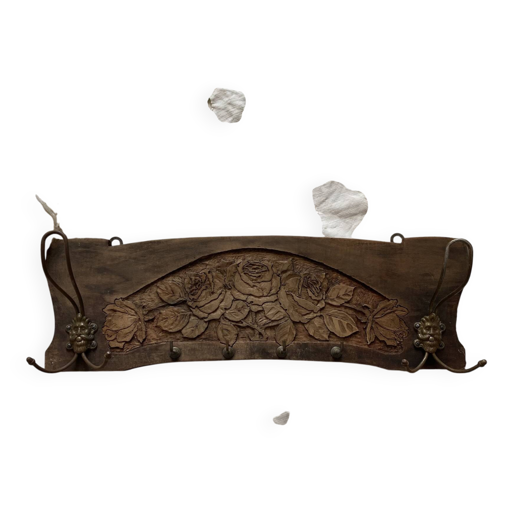 Wall-mounted coat rack in carved wood with rose decoration.