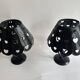 Pair of black wrought iron lanterns with heart patterns, romantic style.