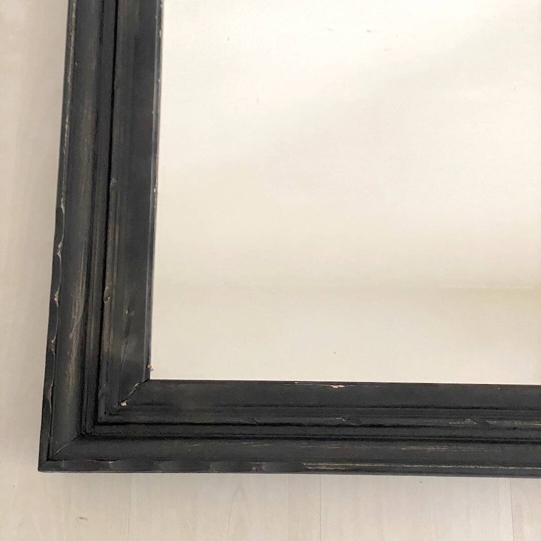 1950s mirror, matte black wood with a patina.