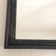 1950s mirror, matte black wood with a patina.