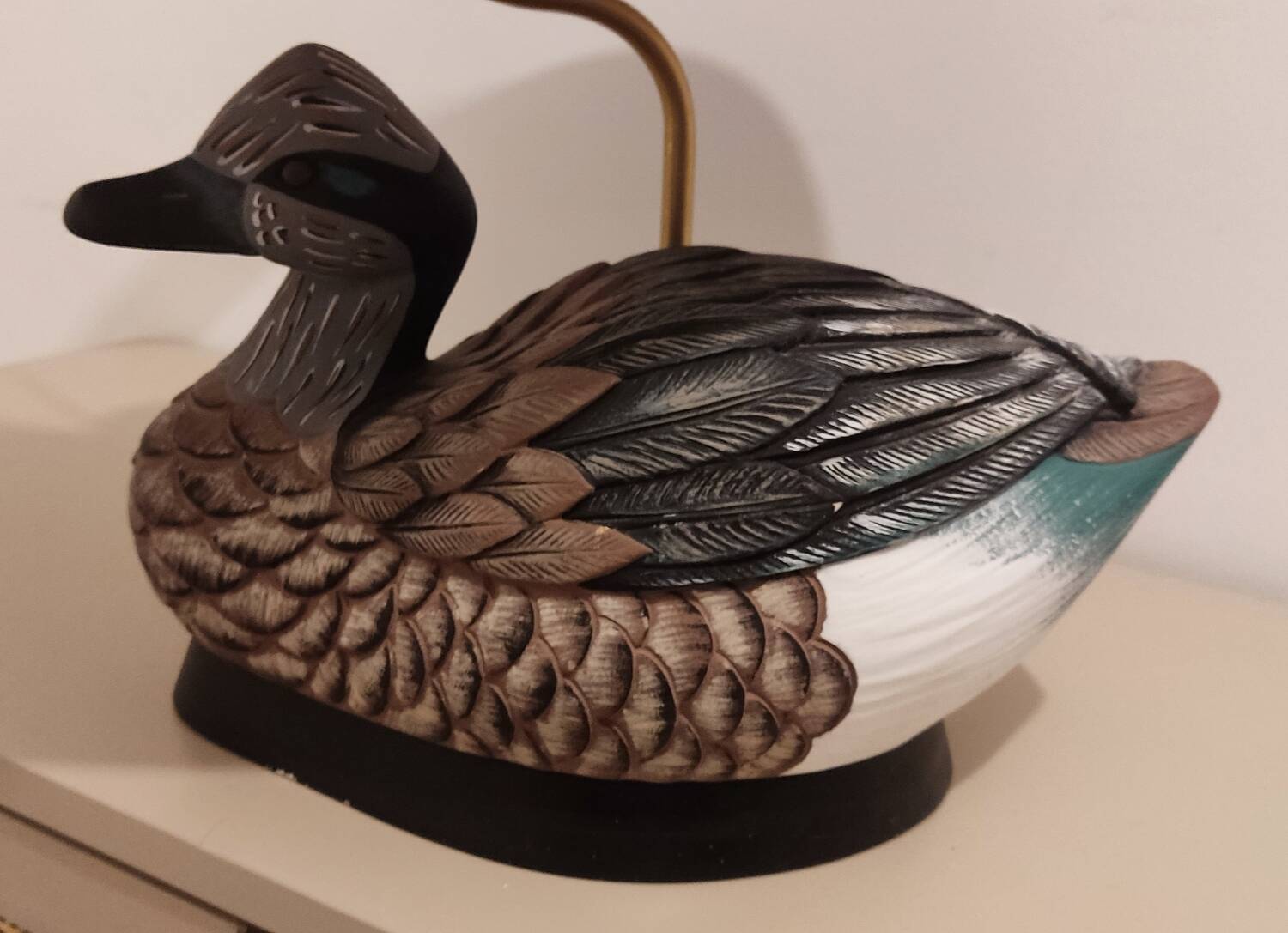 Decorative table lamp with a sculpted duck-shaped base and painted finish.