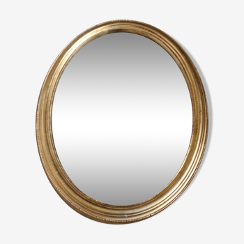 Miroir ovale biseauté doré, cadre en bois et stuc