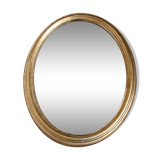 Oval mirror beveled gilded, wooden frame and stucco