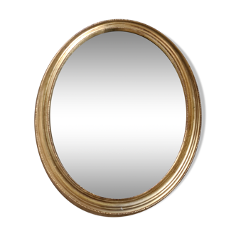 Miroir ovale biseauté doré, cadre en bois et stuc
