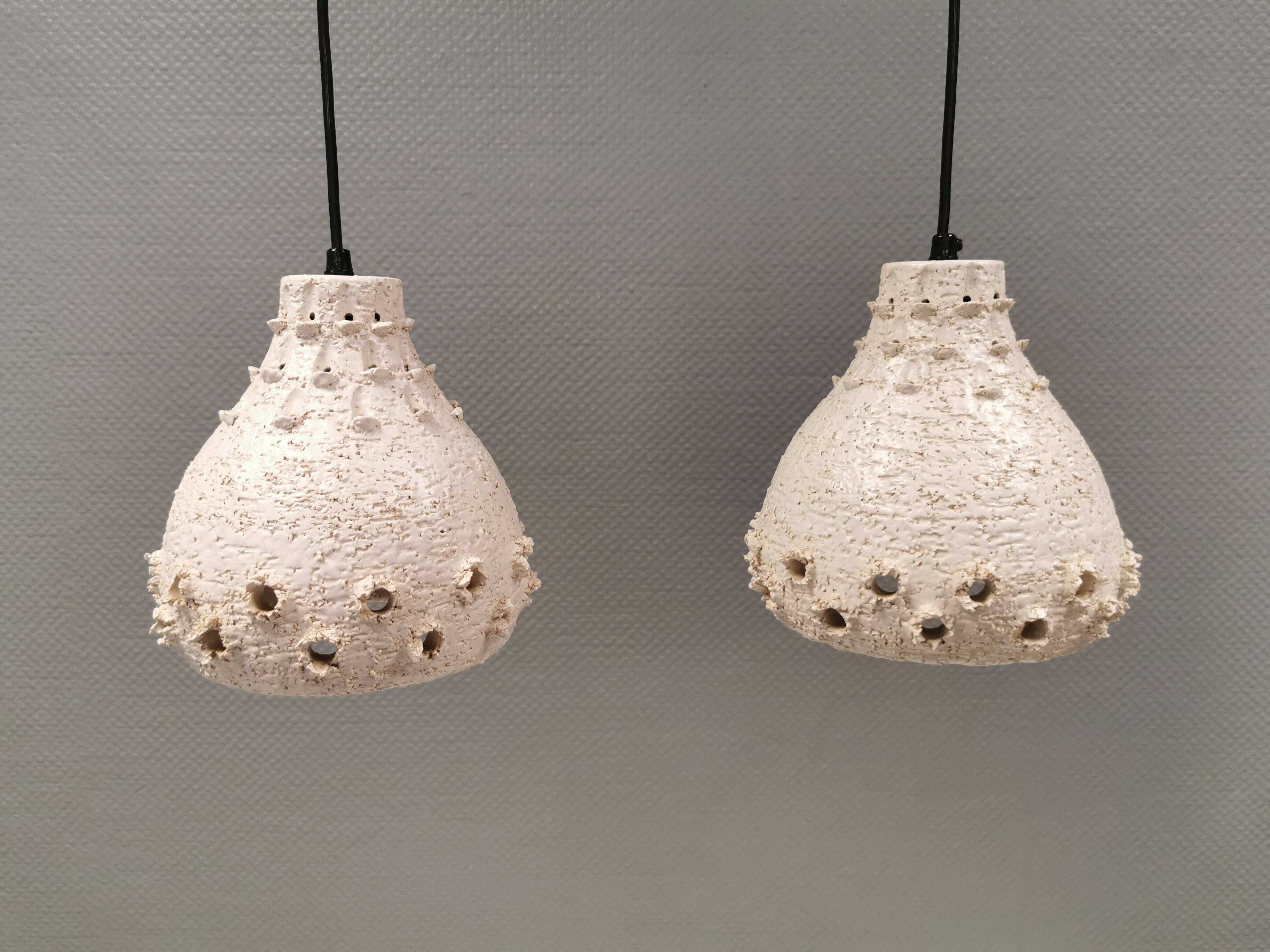 Two ceramic hanging lamps, in creamy white color, looking almost like coral