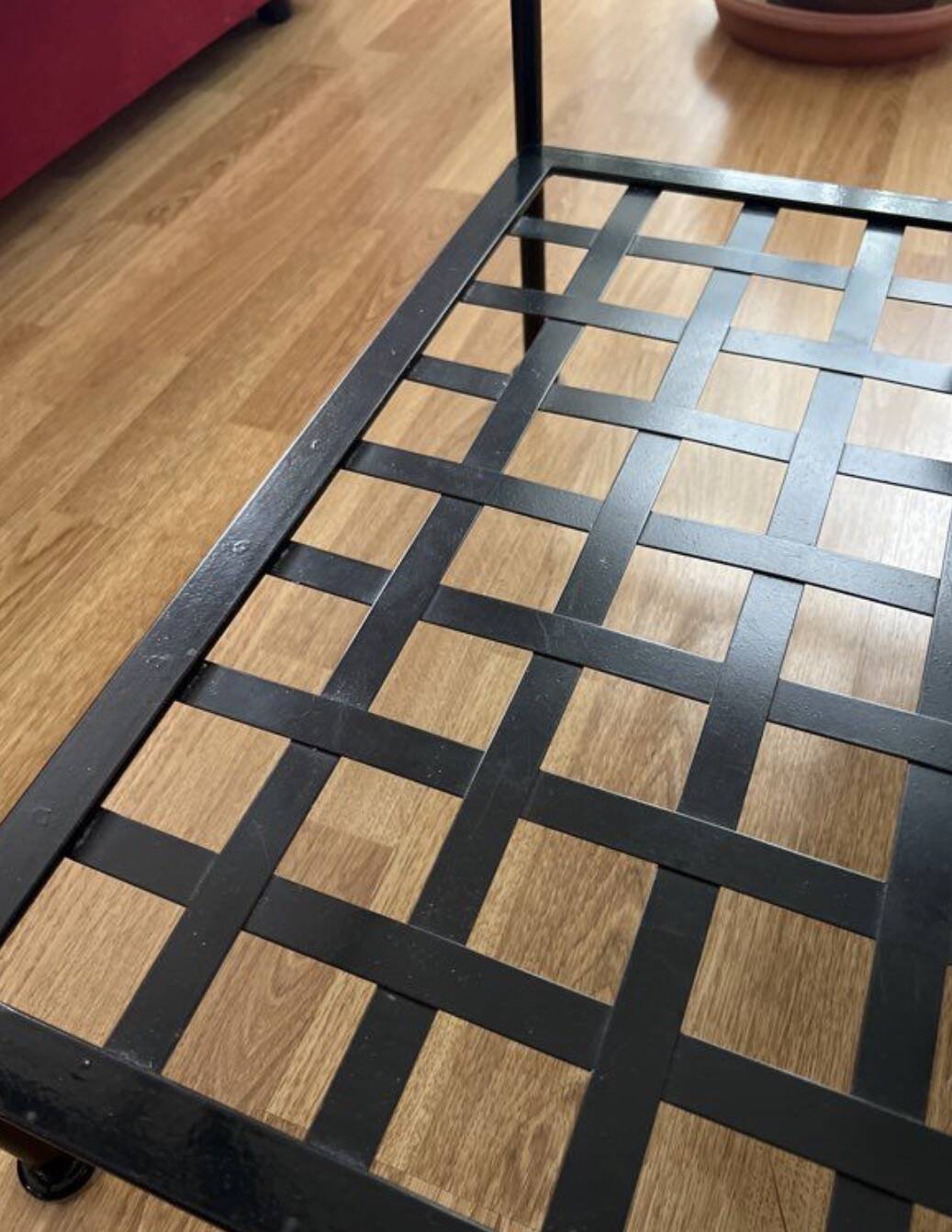 Coffee table with a glass top and black metal frame.