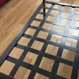 Coffee table with a glass top and black metal frame.