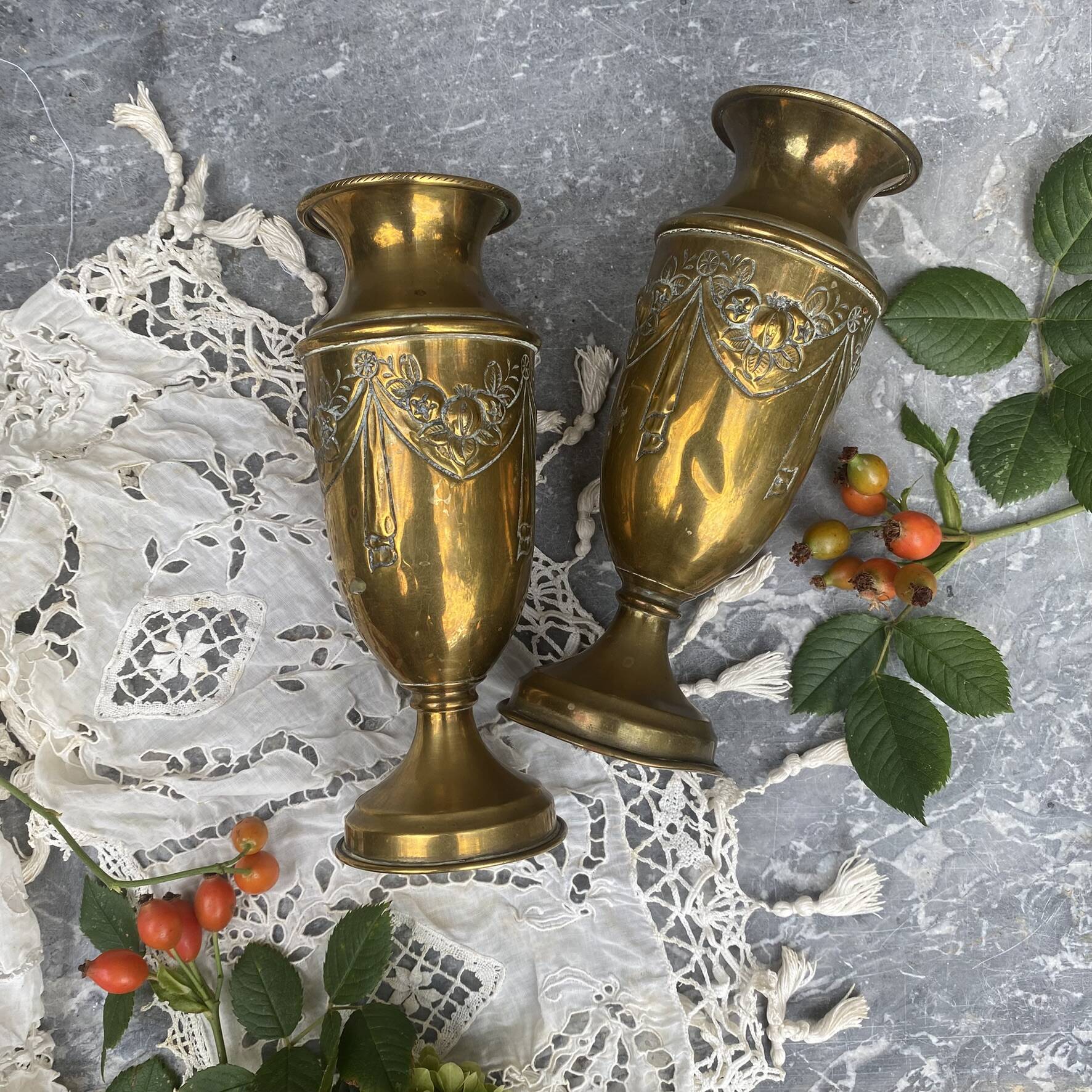 Pair of embossed brass bud vases stamped 17 cm