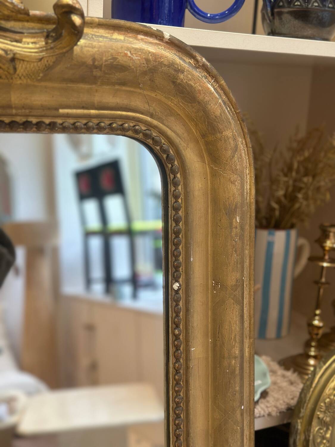 Antique Louis-Philippe mirror carved and gilded with leaf