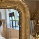 Miroir ancien Louis-Philippe sculpté et doré à la feuille