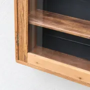 Antique wall display cabinet in natural wood and black – small glass-fronted collector's piece.