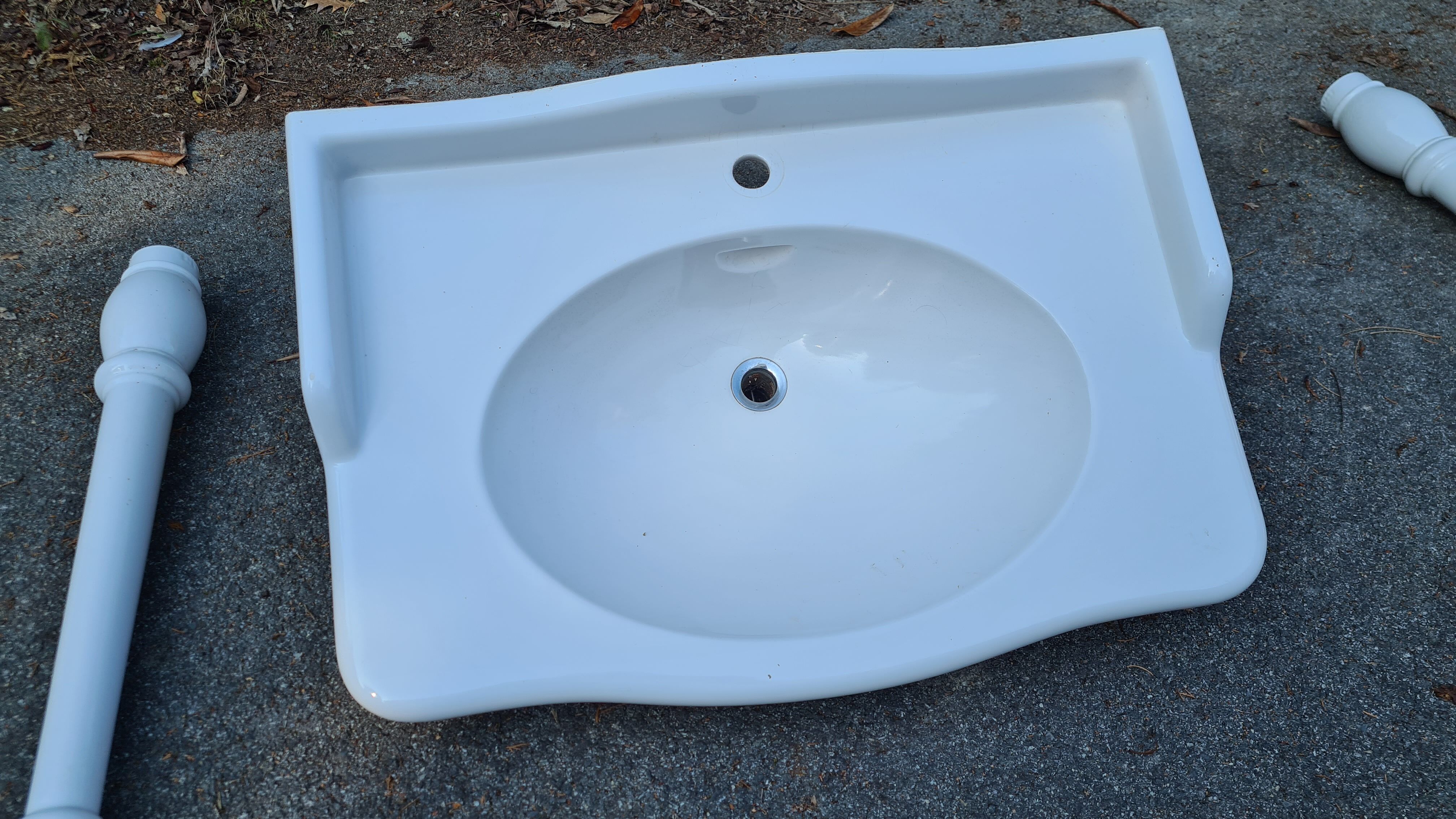 White ceramic wall washbasin with 2 ceramic legs