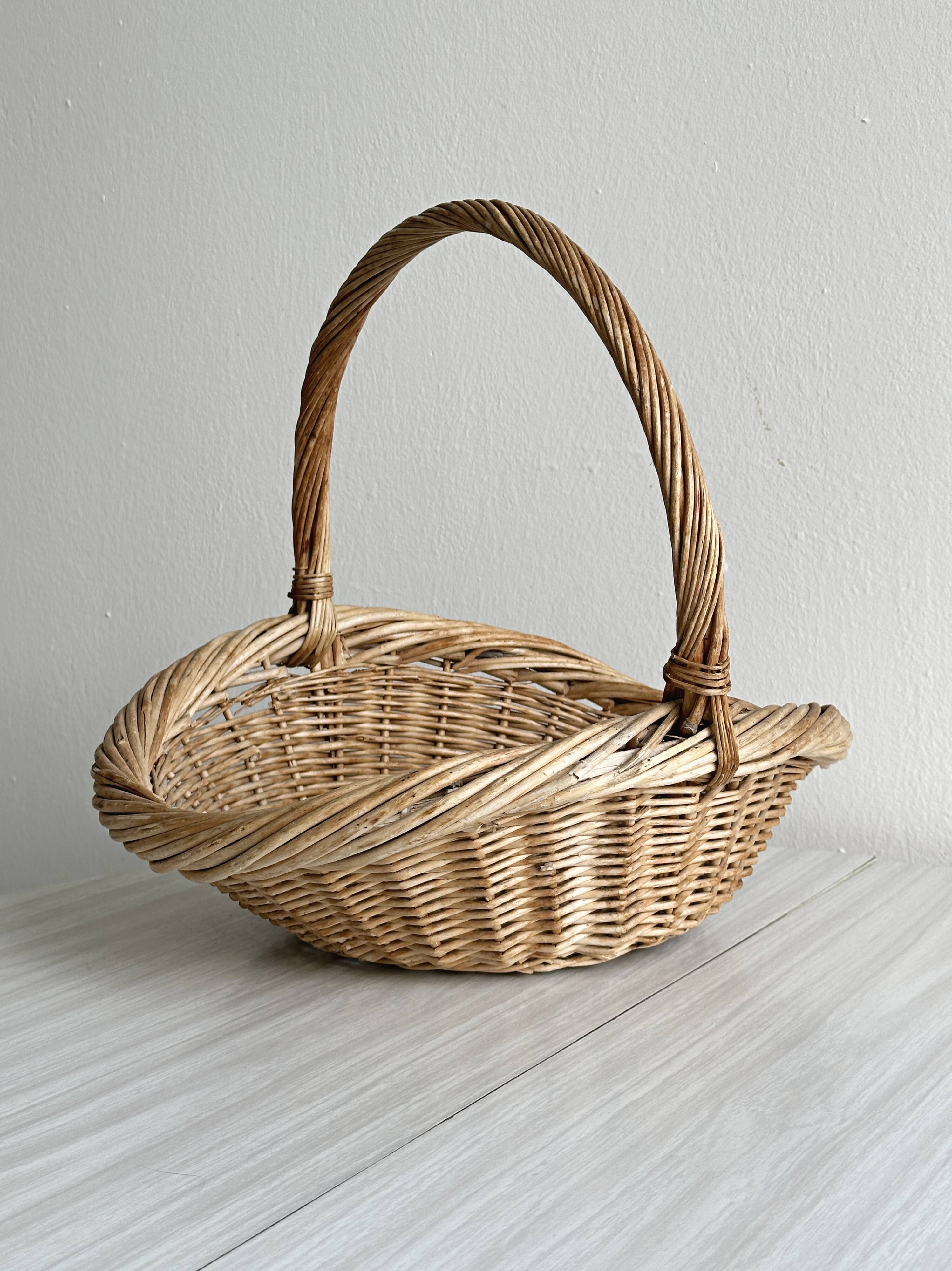 Large antique woven wicker basket with handle.