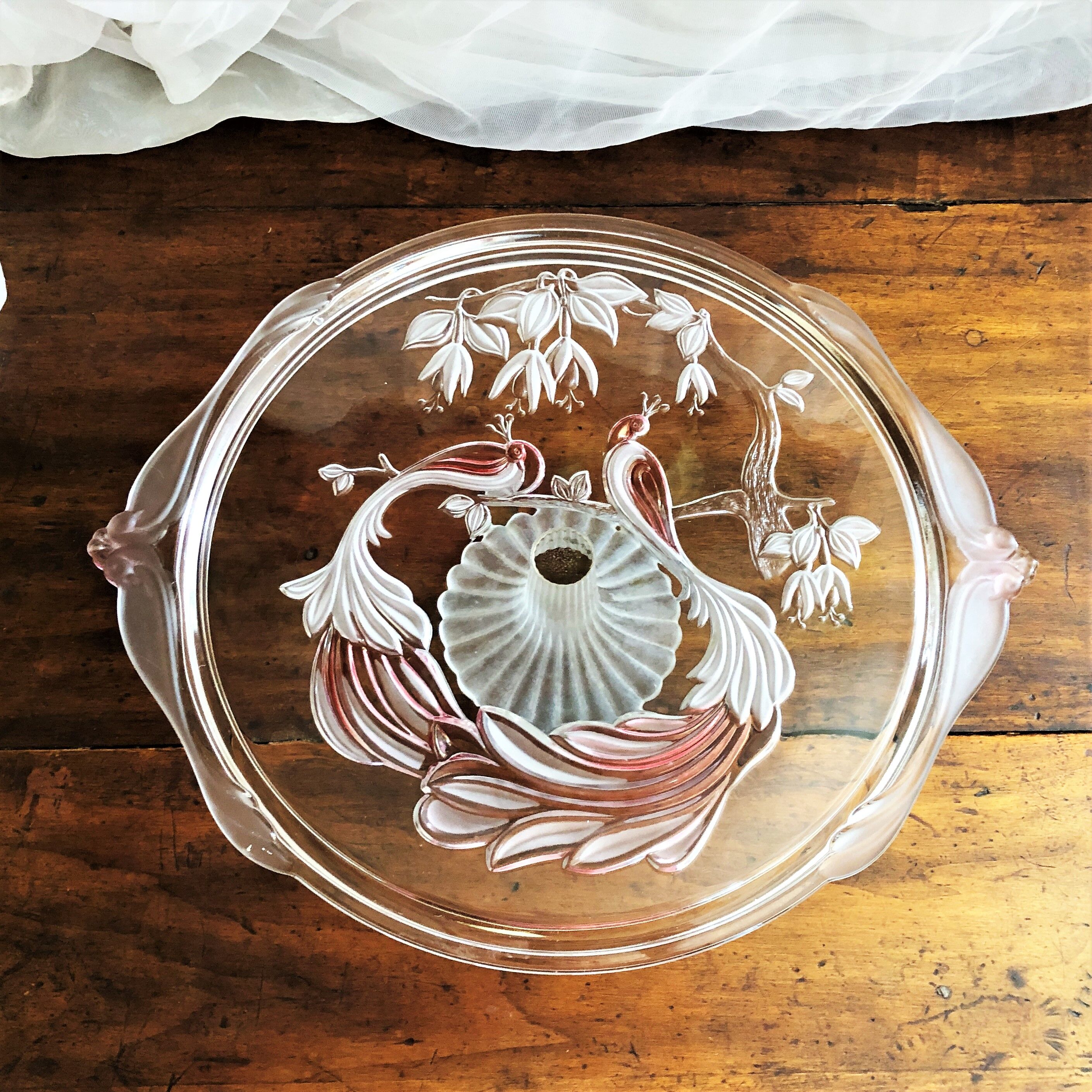 Large pie dish cakes on pedestal decorated with peacocks