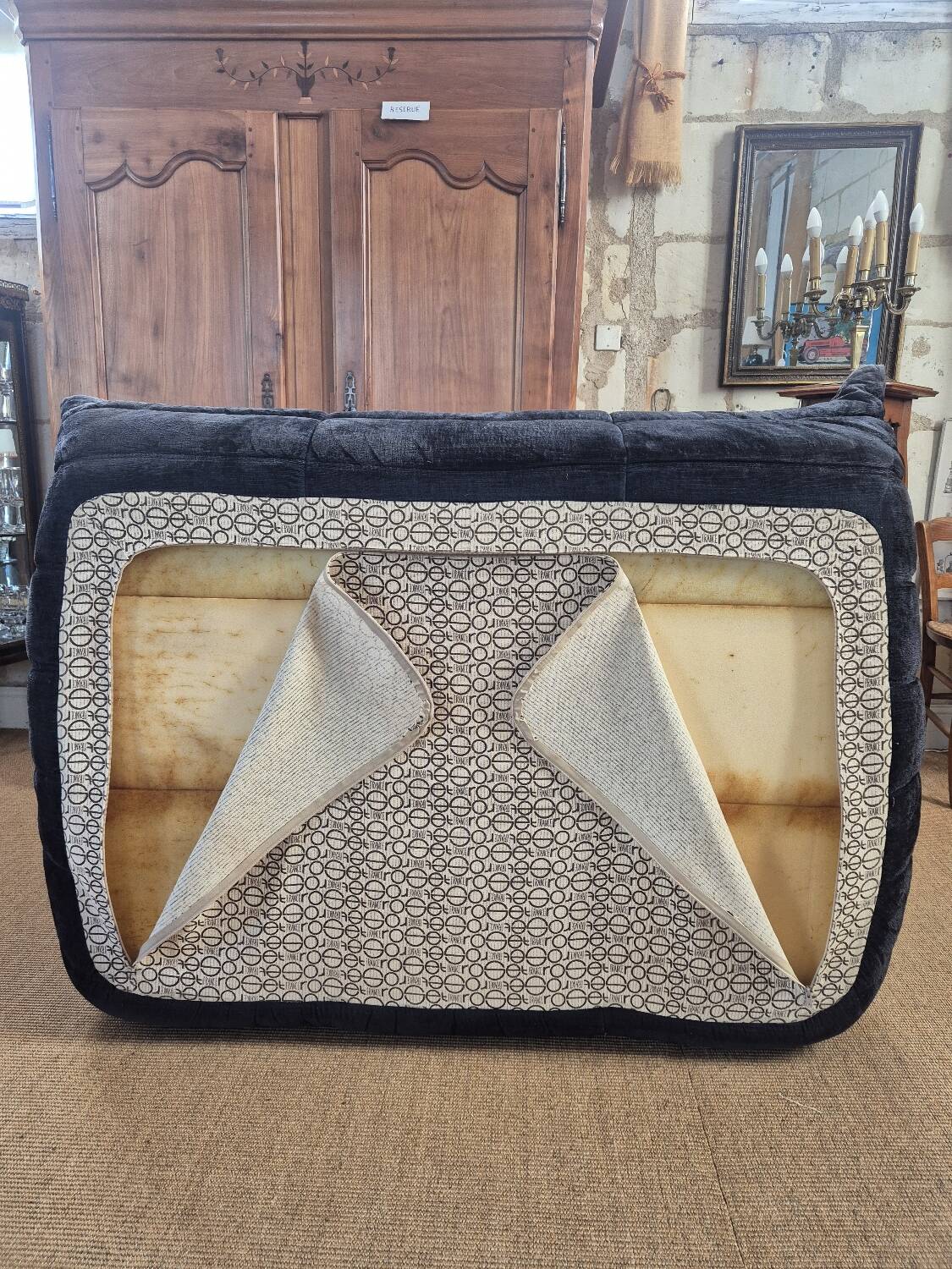 Togo sofa by Ligne Roset and its pouf from the 1970s.