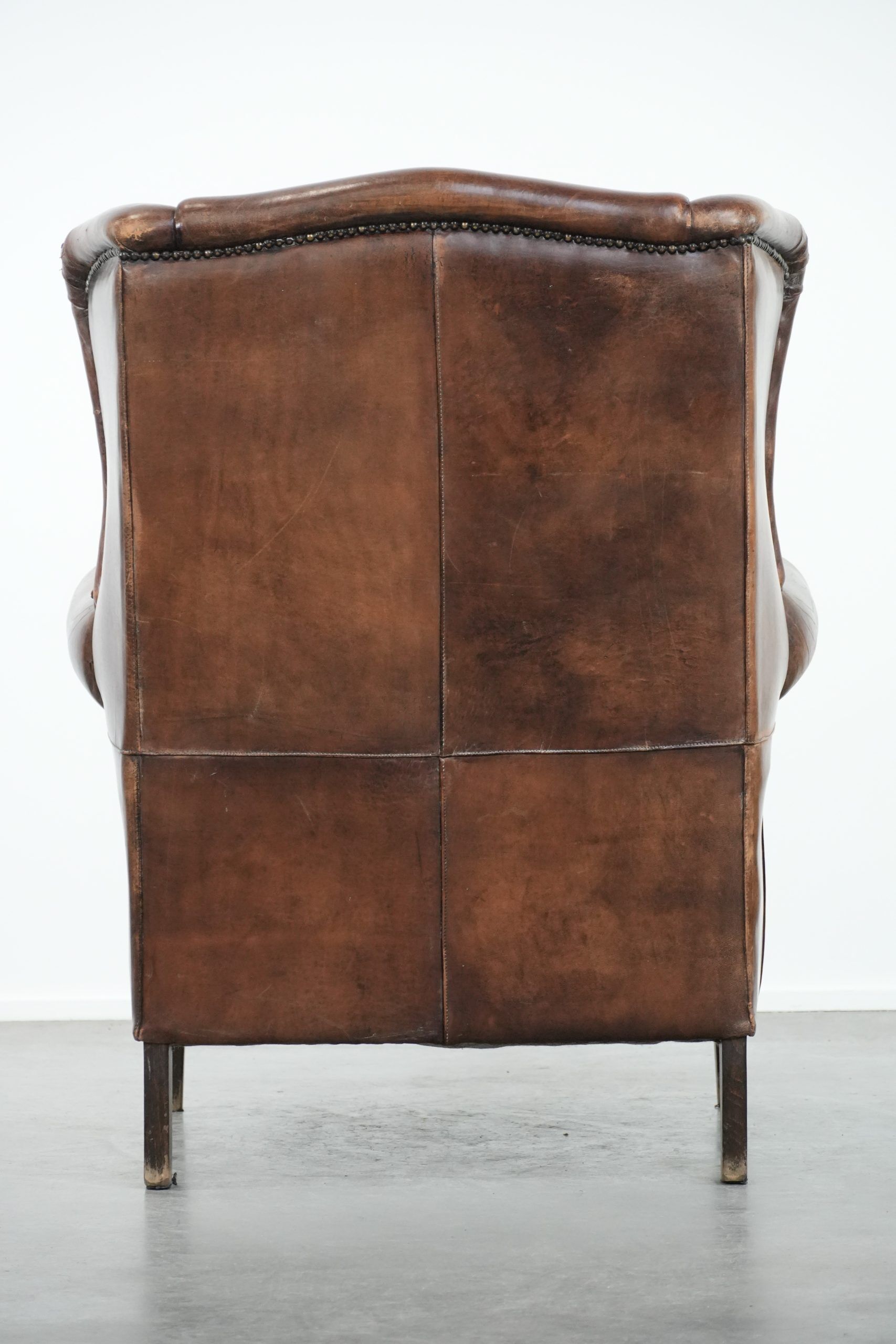Vintage wingback armchair made of sheepskin leather with beautiful colours