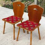 2 curved wood and red fabric chairs