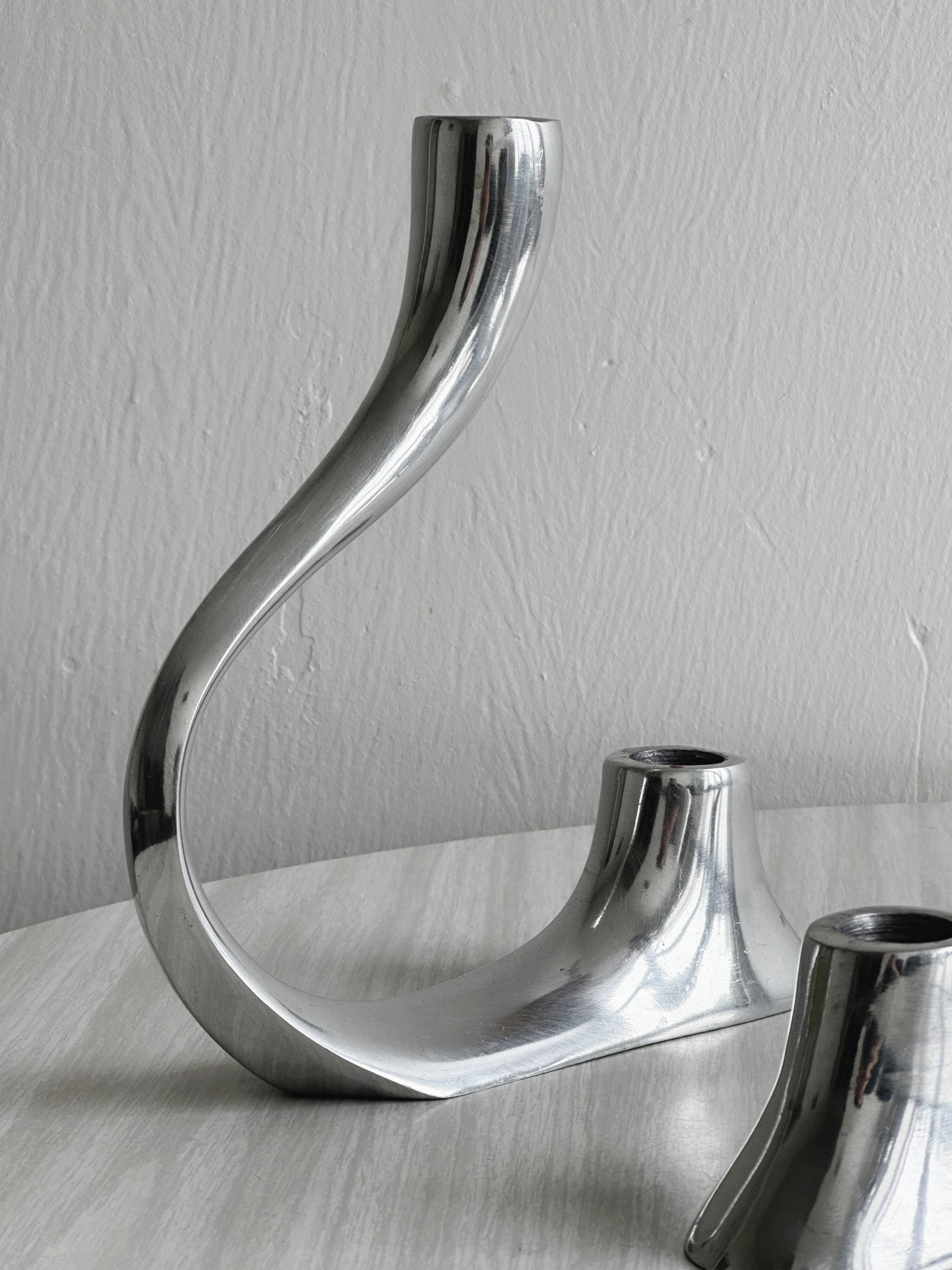 Pair of designer candlesticks in chromed metal
