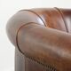 Sheepskin clubarmchair with beautiful patina finished with decorative nails