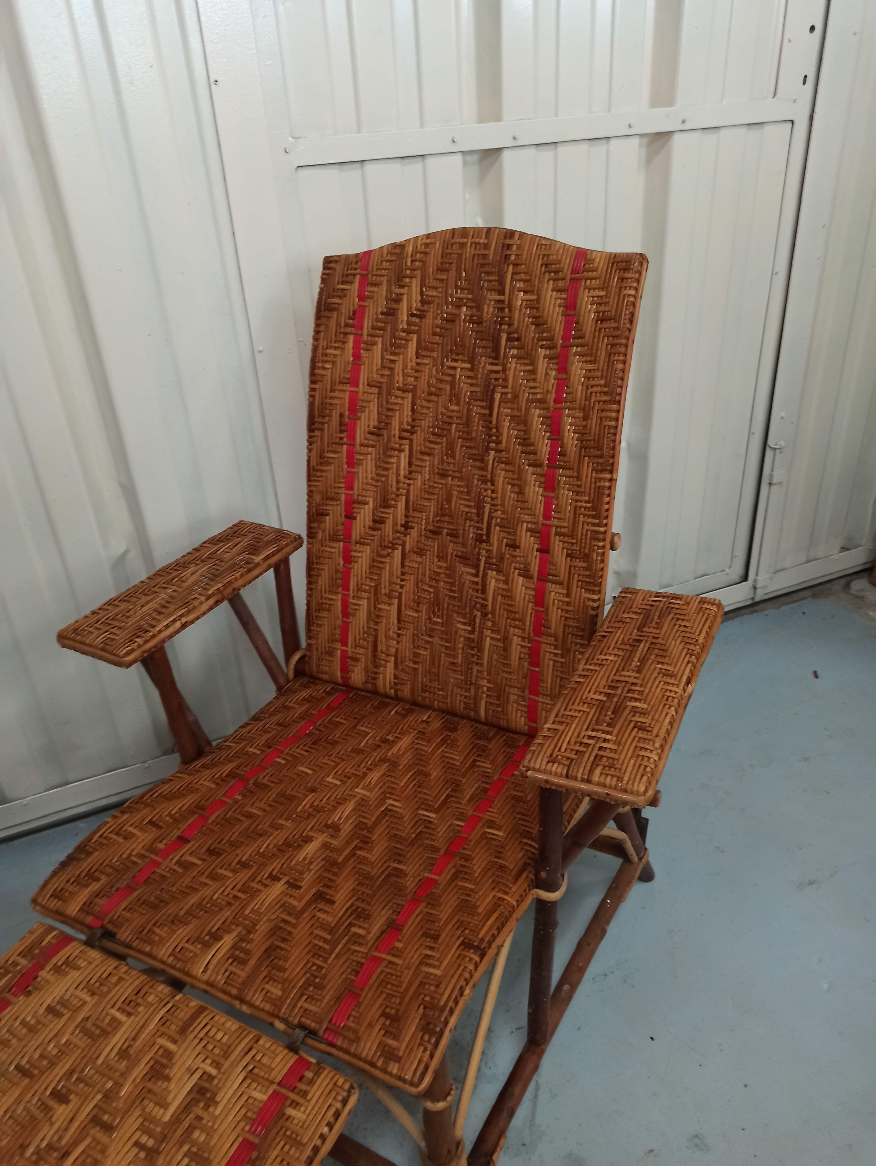 Sunbathing sunbathing in wicker rattan wood deckchair red lounger