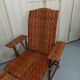 Sunbathing sunbathing in wicker rattan wood deckchair red lounger