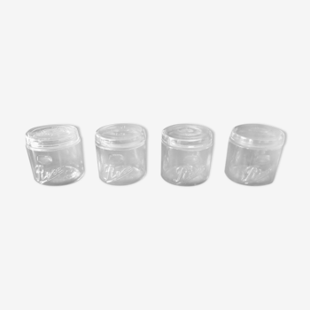 Series of 4 white glass jars