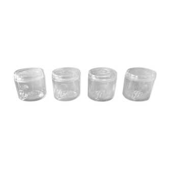 Series of 4 white glass jars
