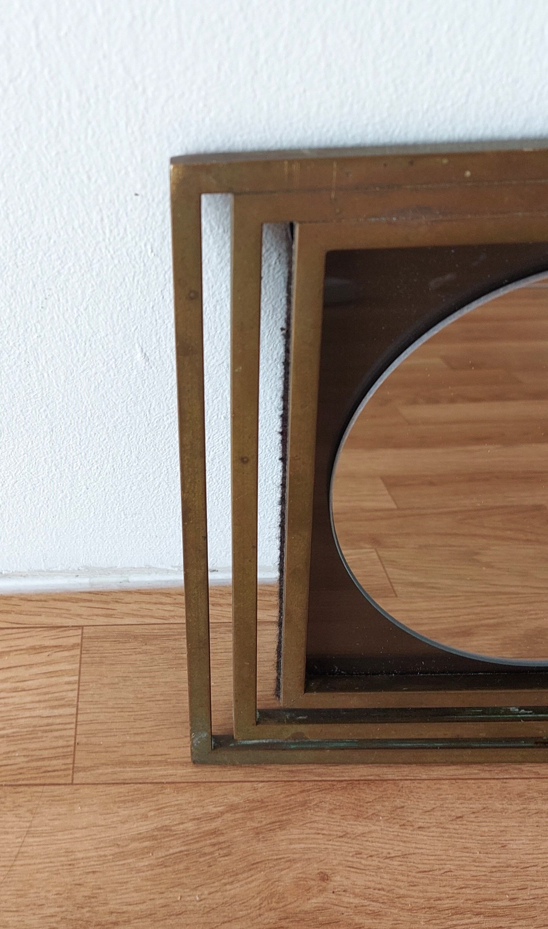 Modernist mirror in gilded brass 1960.