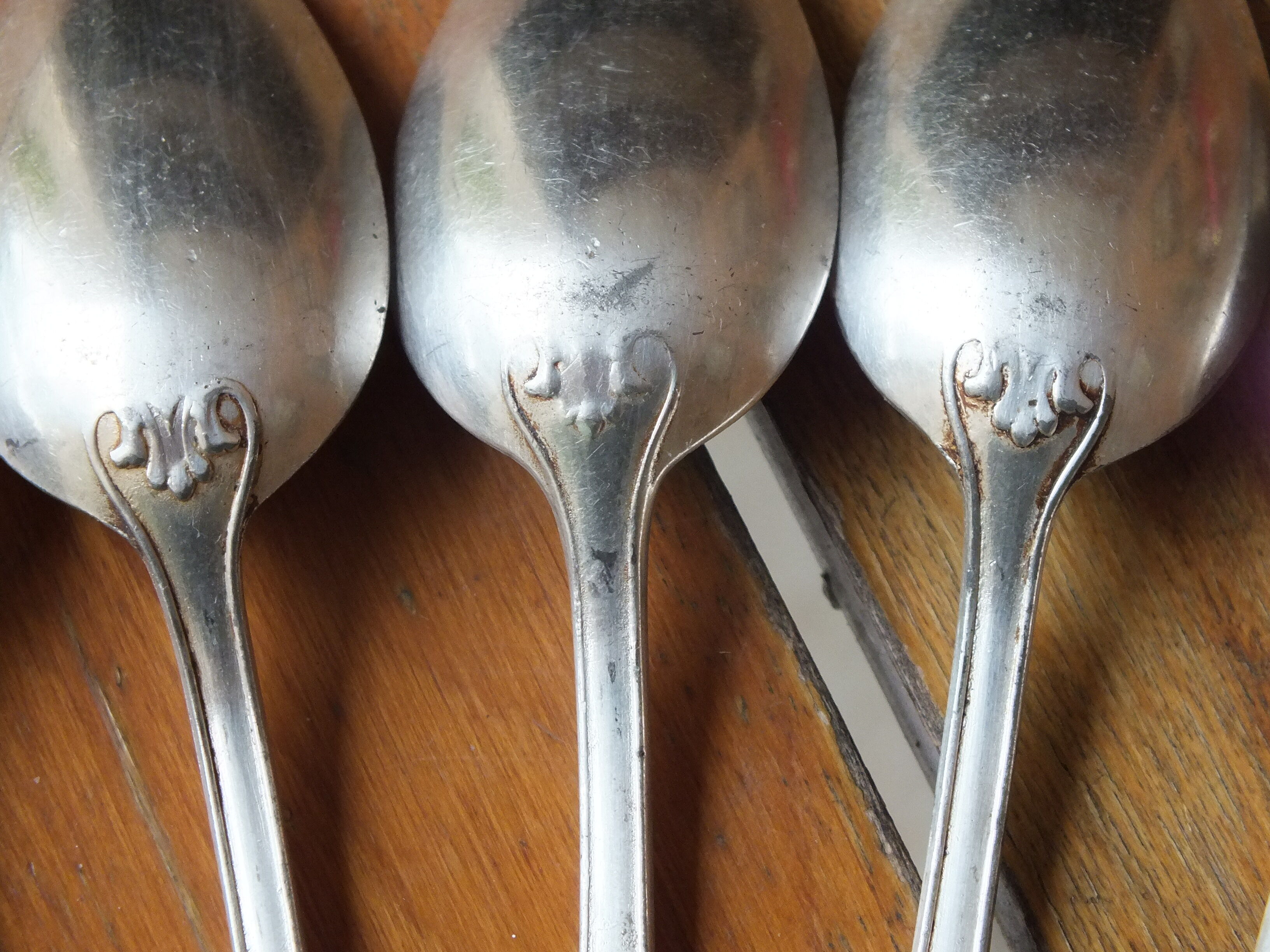 15 small silver metal spoons with rows of beads
