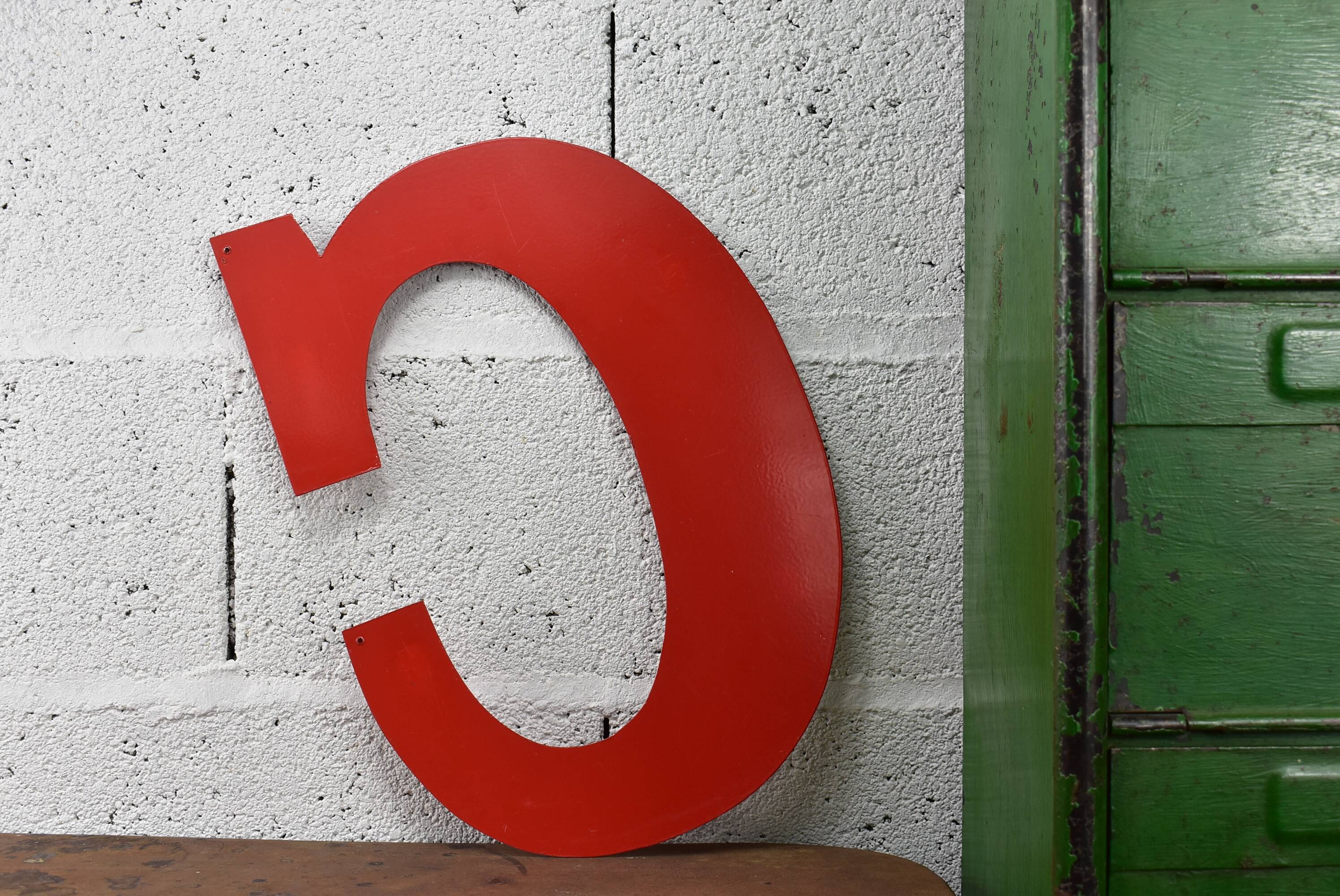 Industrial letter "C" in red metal