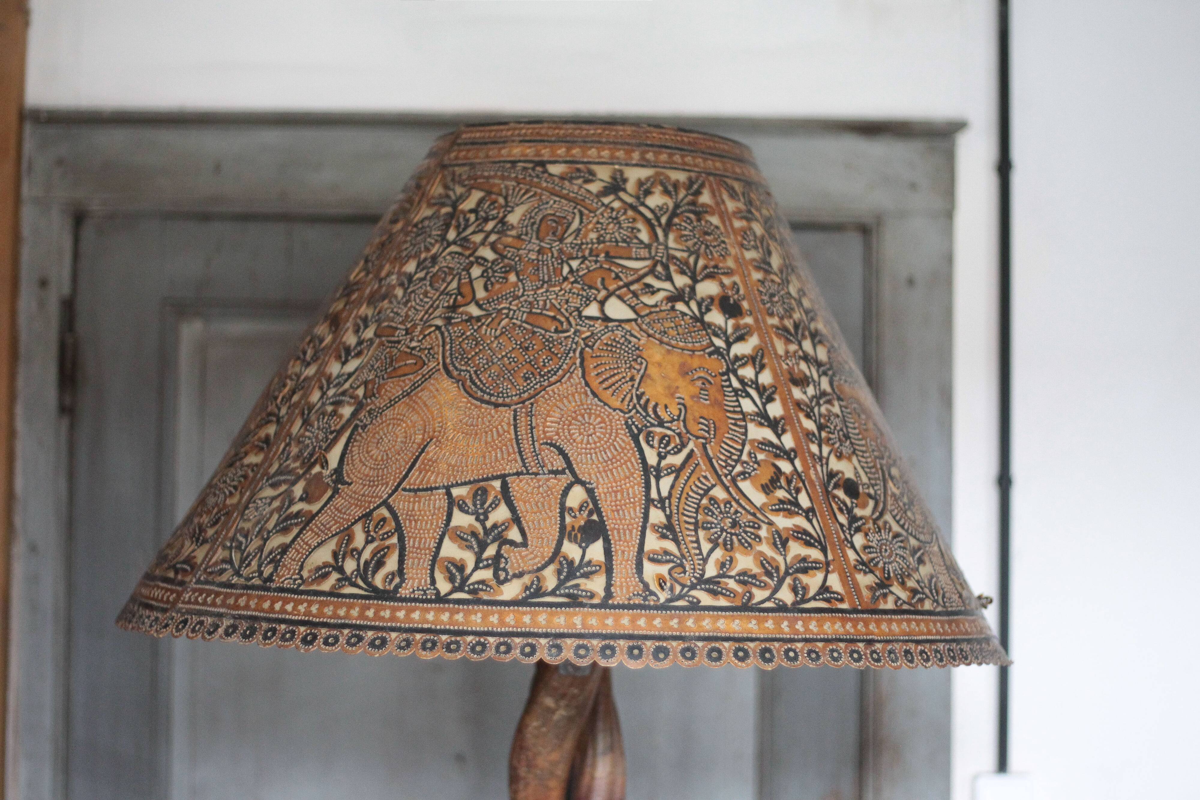 Liane and metal floor lamp with perforated leather shade featuring elephant patterns, lise.