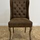 Upholstered armchair in brown imitation leather