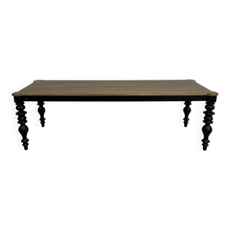 Classic wooden dining table with black legs, seats 12