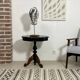 Two-tone black and mahogany pedestal table with mahogany veneer