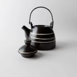 Vintage ceramic teapot from the 1980s, black with white stripes and a metal handle.