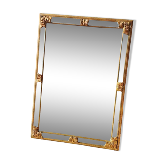 Large mirror with beveled facets in gilded wood from the early 20th century