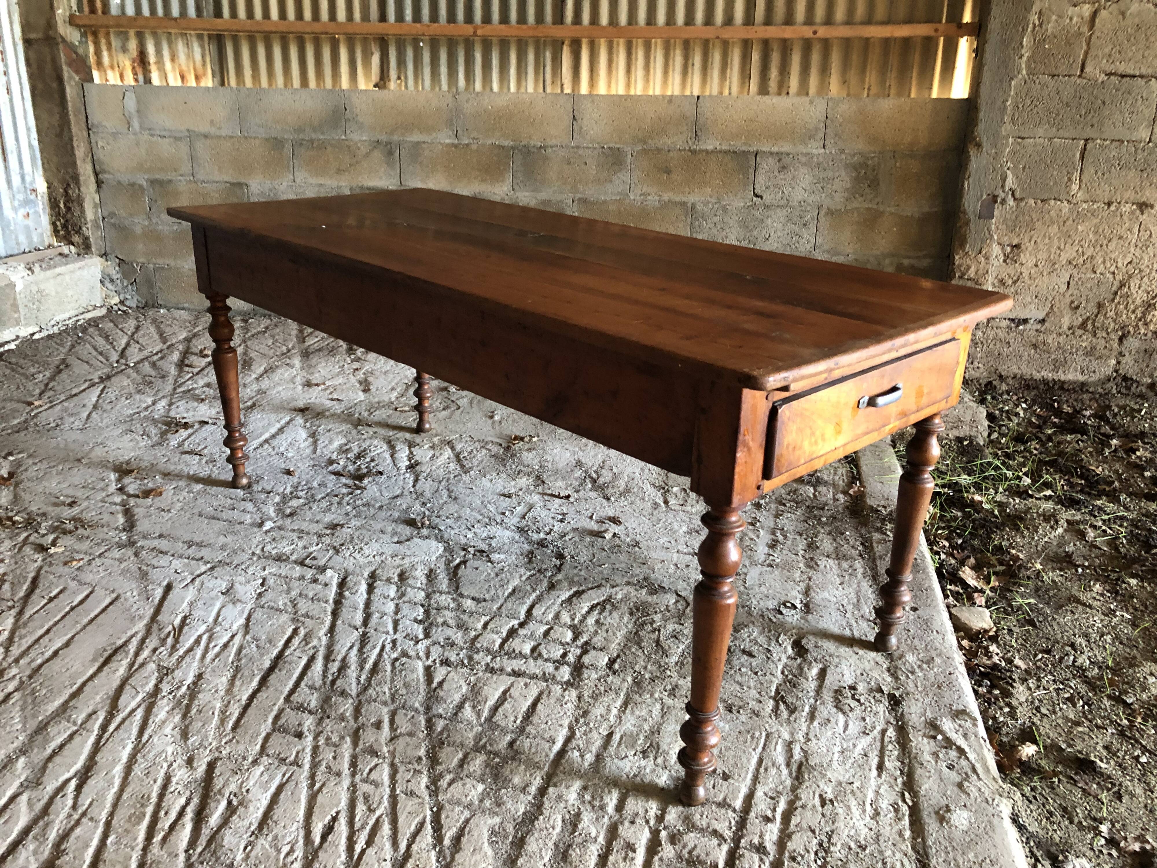 Antique Louis Philippe style farm table in solid cherry wood with turned base.
