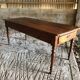Antique Louis Philippe style farm table in solid cherry wood with turned base.