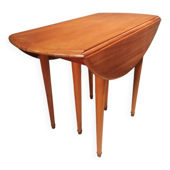 Drop-leaf table with 6 legs and 3 extensions.