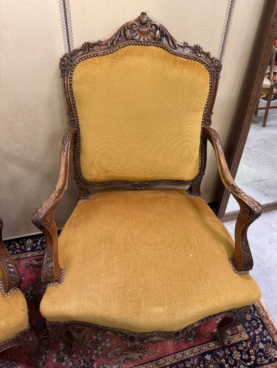 Pair of faux Louis XV armchairs in fully carved walnut