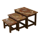 Set of three nesting tables in rosewood with a brutalist petrified wood top from the 1960s.