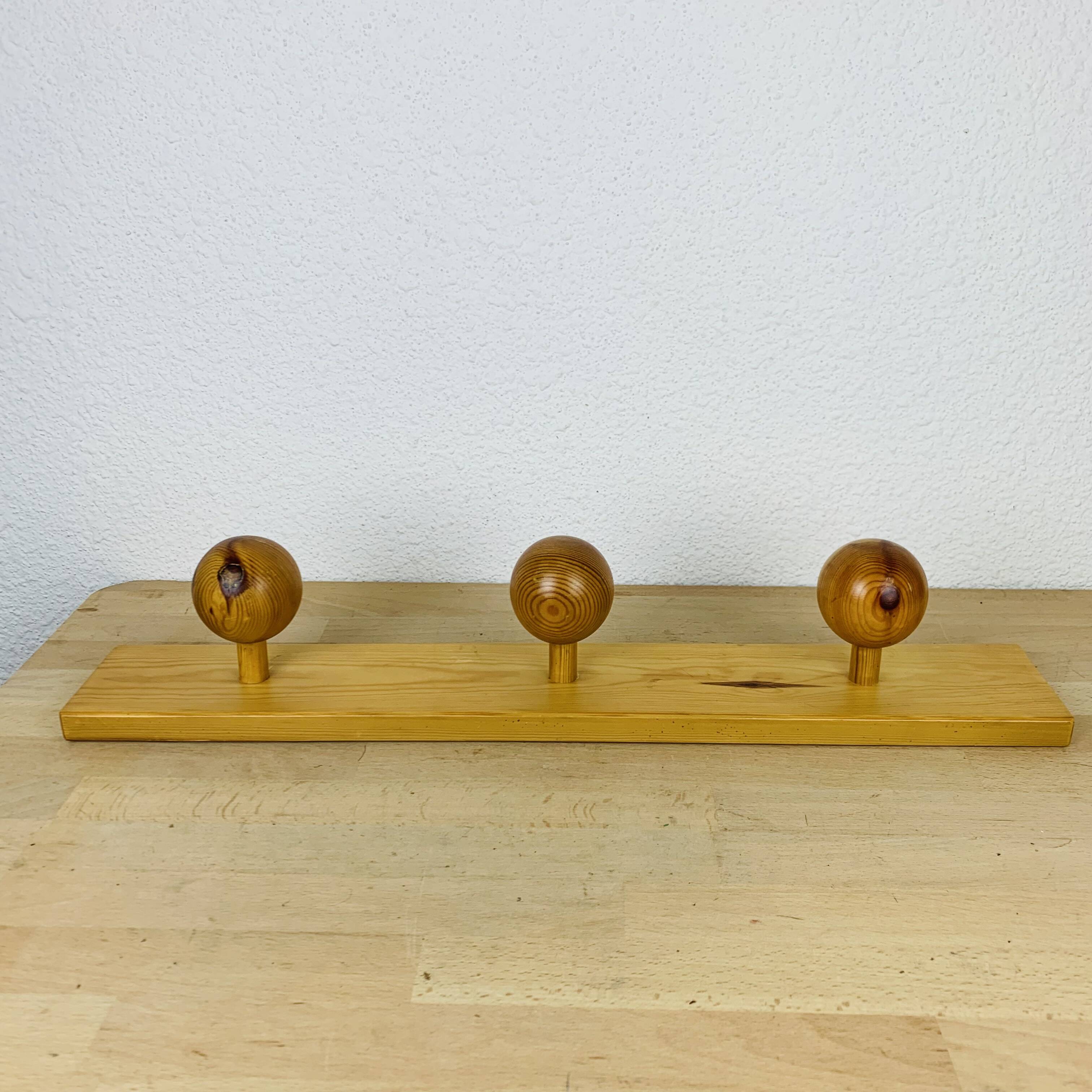 Wall coat rack with pine ball hook