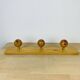 Wall coat rack with pine ball hook