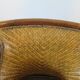 Colonial style armchair in woven rattan and exotic wood