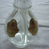 A liquor decanter has 4 compartments in glass