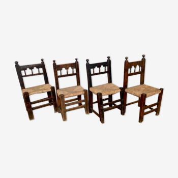Series of 4 brutalist rustic chairs in carved wood straw seat